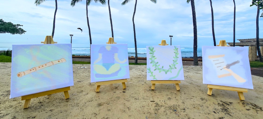 Four art boards and easels on the sand